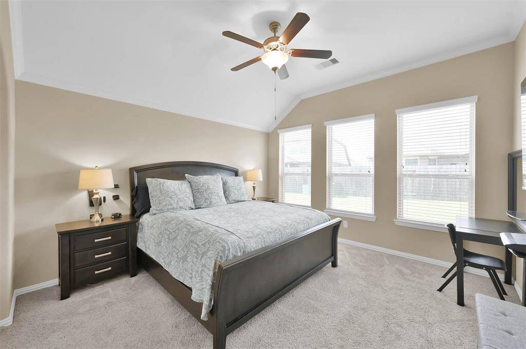 Primary bedroom is located on the first floor separate from the other bedrooms. The tiered ceiling, ceiling fan and plush carpet provides a relaxing place to rest.