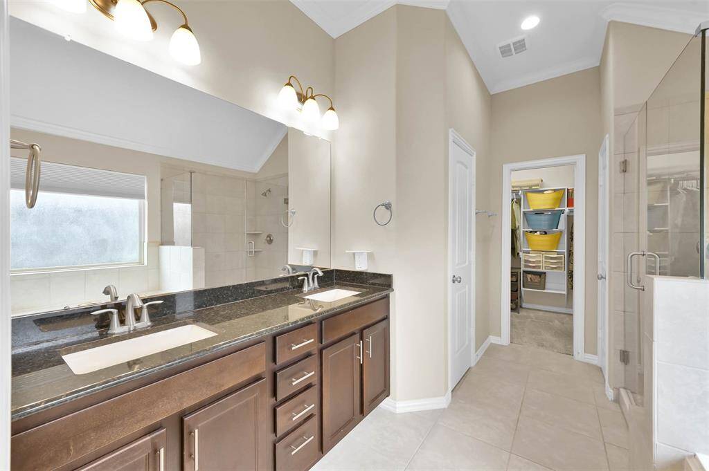 A luxurious ensuite primary bathroom provides plenty of room to prepare for the day