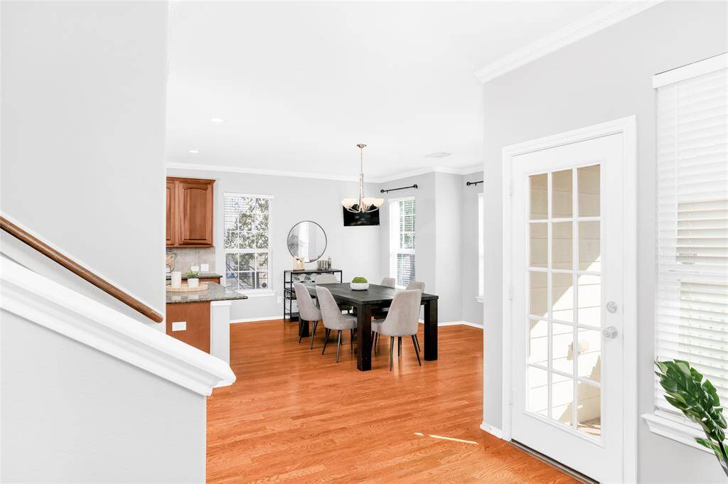 Here you see the dining room and kitchen from the living area. The single French door leads to a balcony that overlooks the yard.