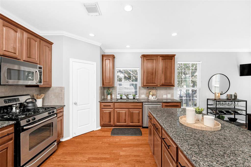 All stainless steel appliances stay including the side by side refrigerator, microwave, gas range and dishwasher.  Great pantry space by the range.