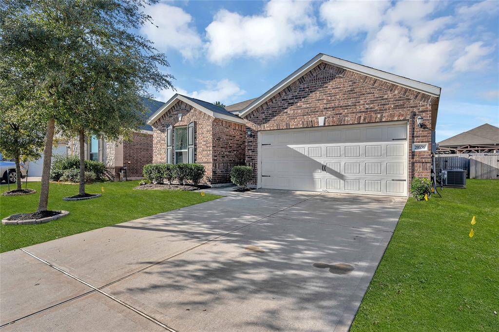 Charming brick single-story home with a two-car garage, well-maintained lawn, and mature trees. Features a spacious driveway and attractive landscaping, offering great curb appeal.