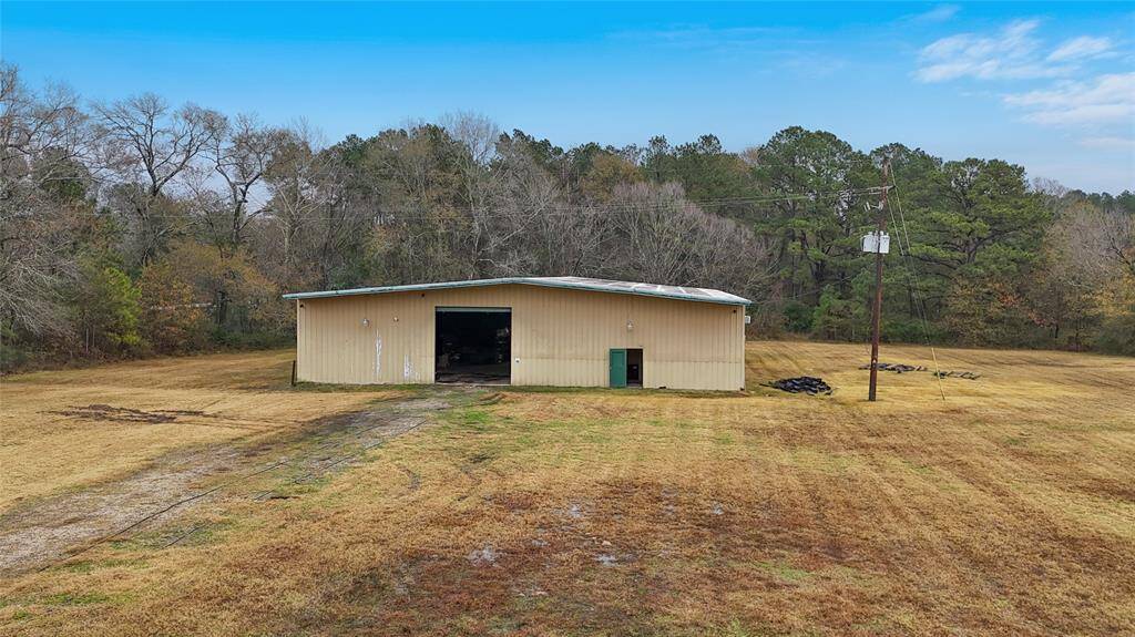 The large, spacious metal building with 14 ft roll up doors on either side surrounded by lots of empty space is perfect for truck pull through for loading and storage