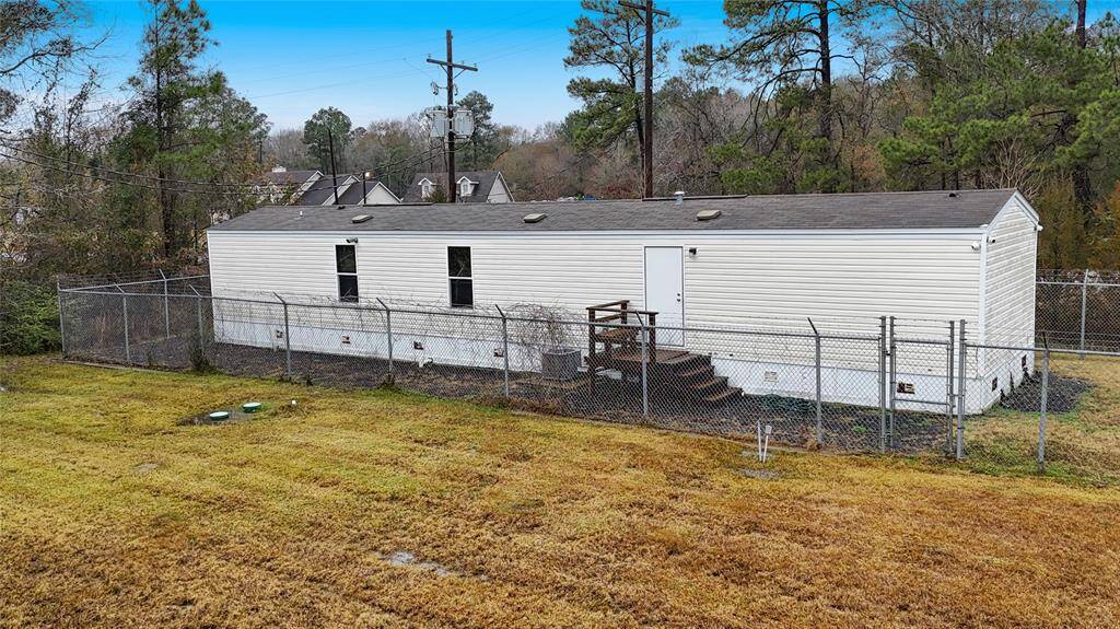 The mobile home is 3 bed/ 2 bath with a full kitchen and laundry room.  It is secured with a fence.  Perfect for office or a caretaker to live.