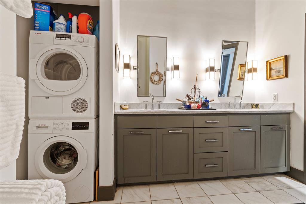 Double vanity in bathroom with washer/dryer