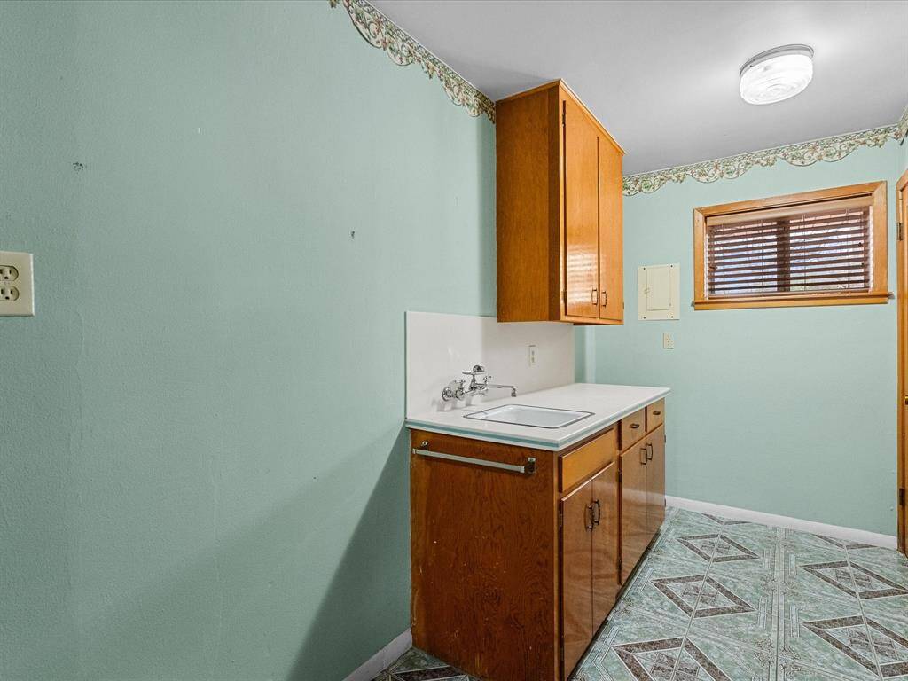 Light & bright space in the utility/laundry room. Upper & lower cabinets, space for refrigerator or upright freezer