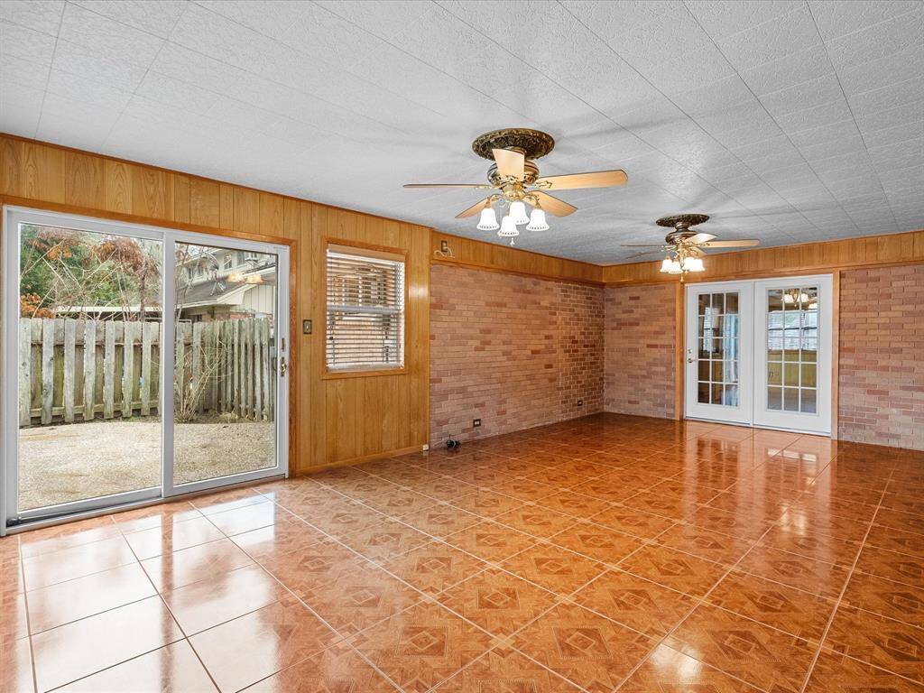Spacious house addition is ideal for family room, recreation, work-out room, home office, craft space, tv room  -- whatever suits your lifestyle needs. Plenty of natural light from large sliding glass doors opening to the back patio.