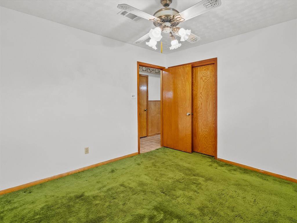 Third of three secondary hallway bedrooms.