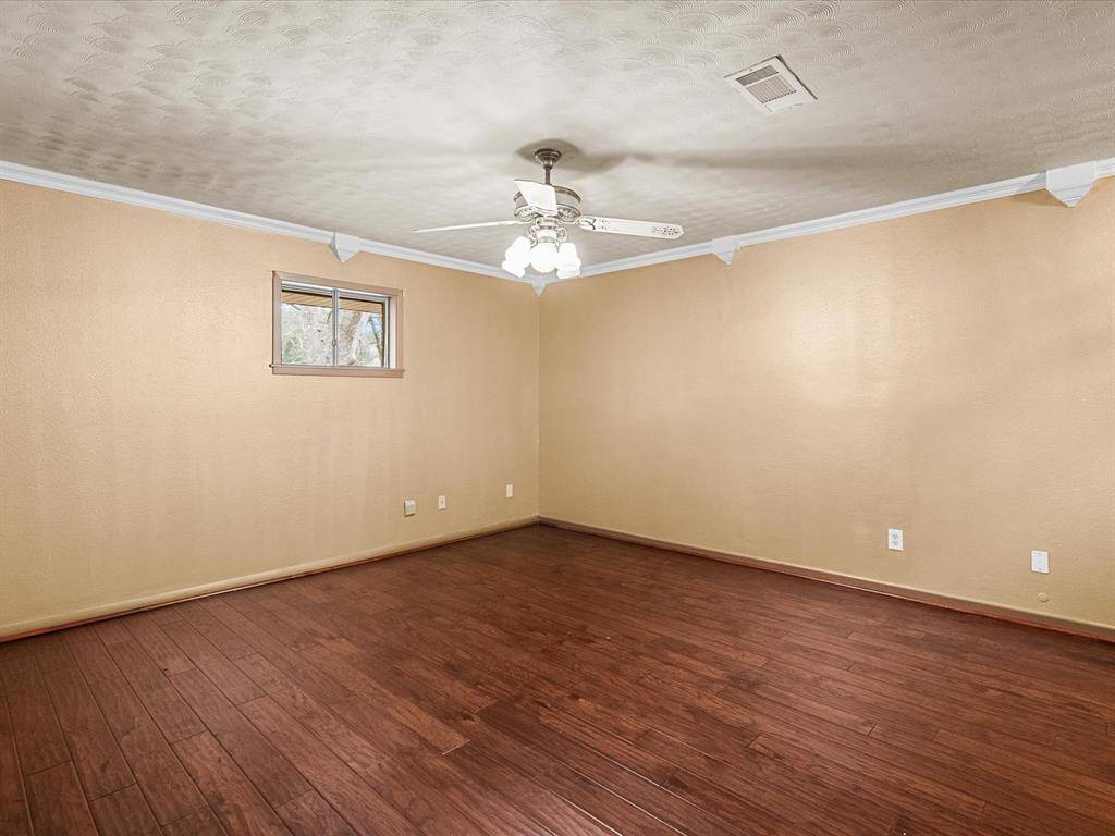 Ample space in the primary bedroom for your full, oversized bedroom suite.