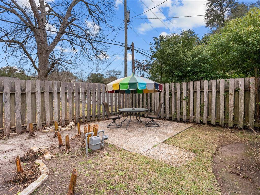 Cozy patio area in one corner of the fully fenced backyard.