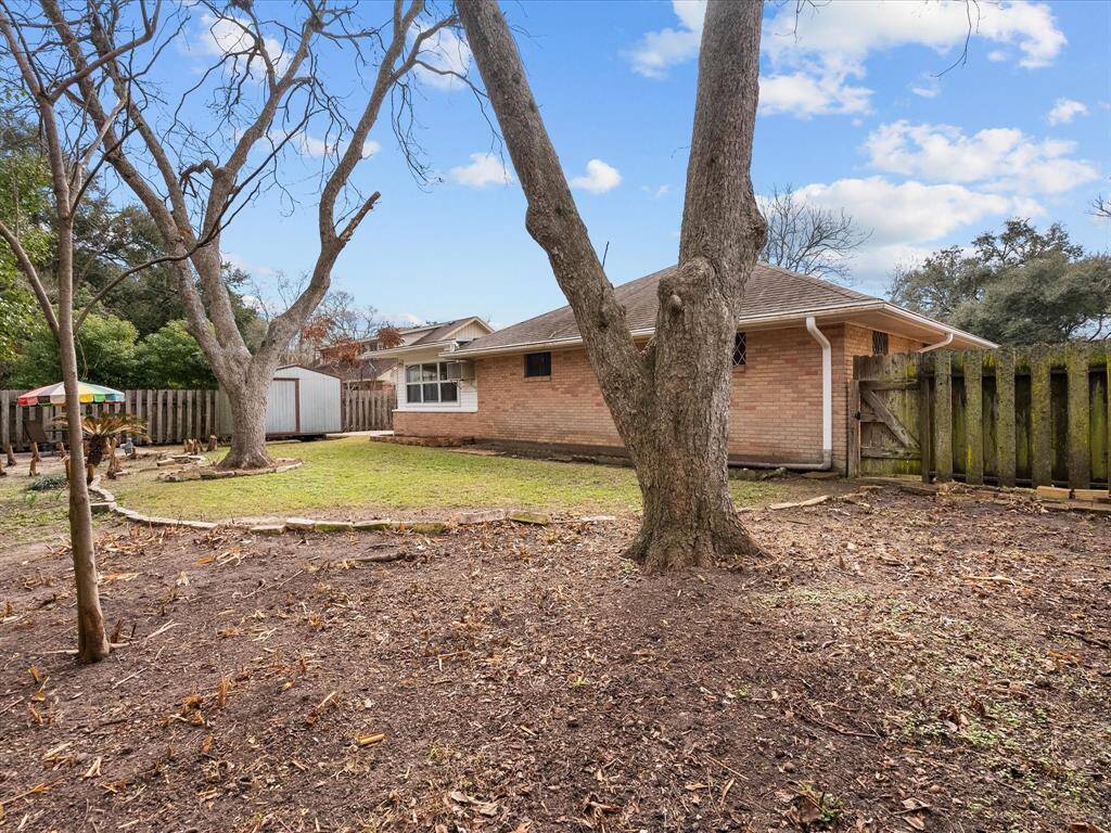 *Note: pics after winter freeze of Jan. 2025 - Spacious backyard with mature trees, a well-maintained lawn, and a storage shed. It features a wooden fence for privacy, offering a serene outdoor space. Perfect for gardening or entertaining.