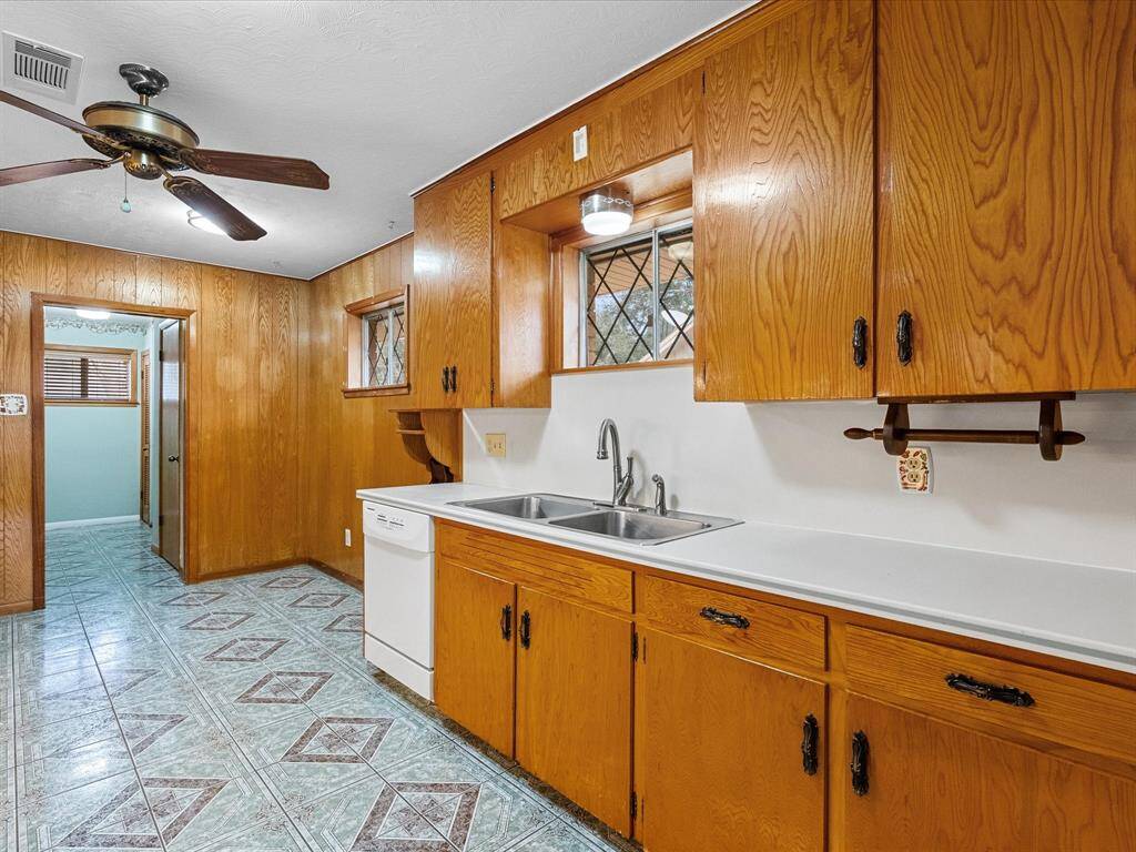Loads of wooden cabinets, double sink, unique patterned flooring -- and who doesn't love a window over the kitchen sink ?  **All cabinets are tile-lined - open a cabinet to take a look !