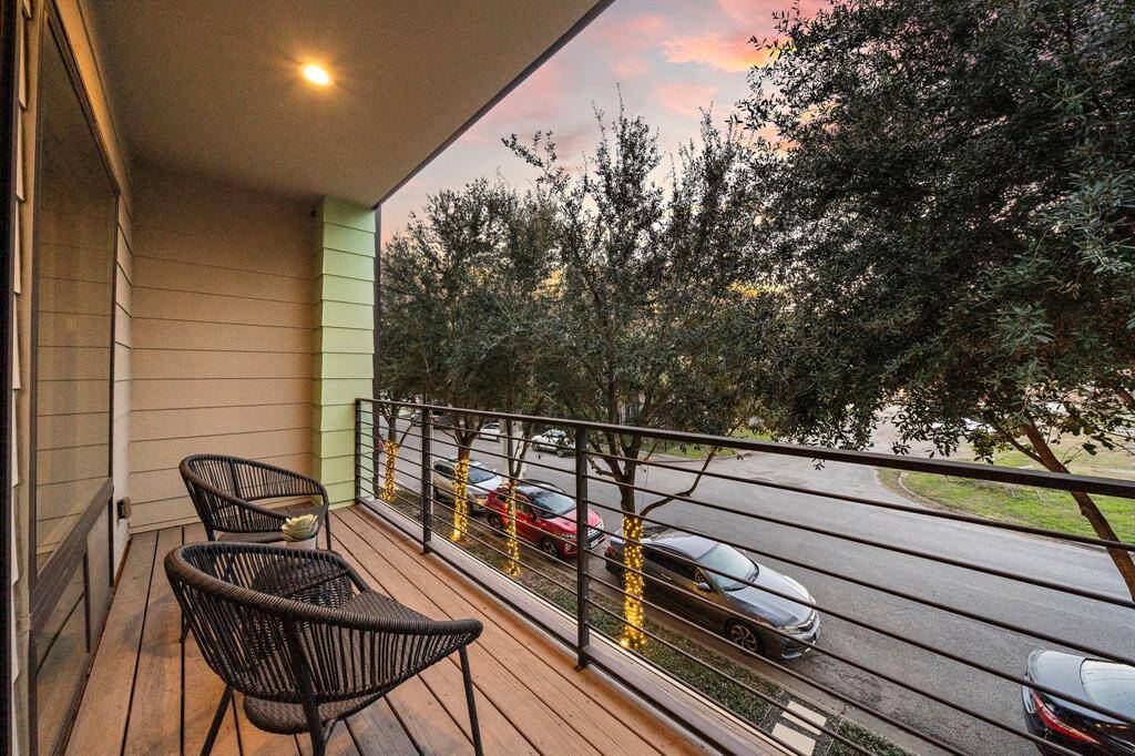 Enjoy peaceful moments on the expansive covered balcony, featuring a pergola for added privacy. Overlooking the vibrant streets of La Ville Saint Emanuel, this open-air space is ideal for relaxation or casual gatherings, enhancing the home's seamless indoor-outdoor lifestyle.