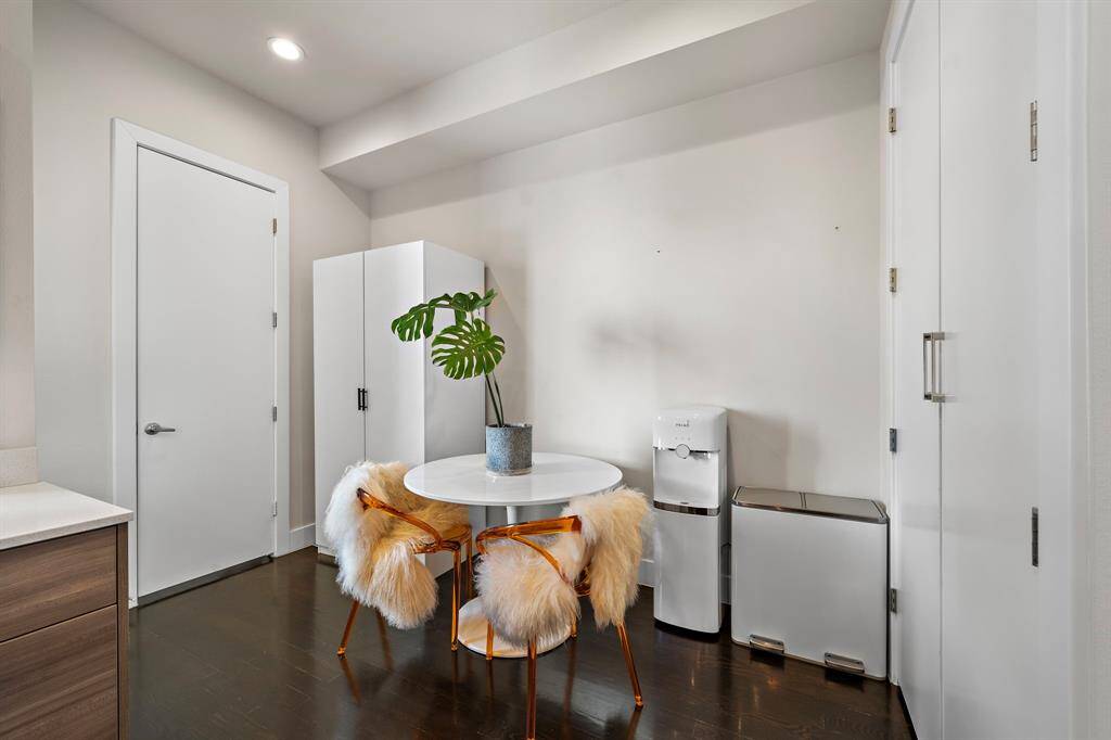Located in the kitchen area, the cozy breakfast nook features plush seating for casual dining. Its proximity to the kitchen ensures convenience, while the clean design and hardwood flooring maintain the home's contemporary aesthetic. Ideal for morning coffee or casual meals.