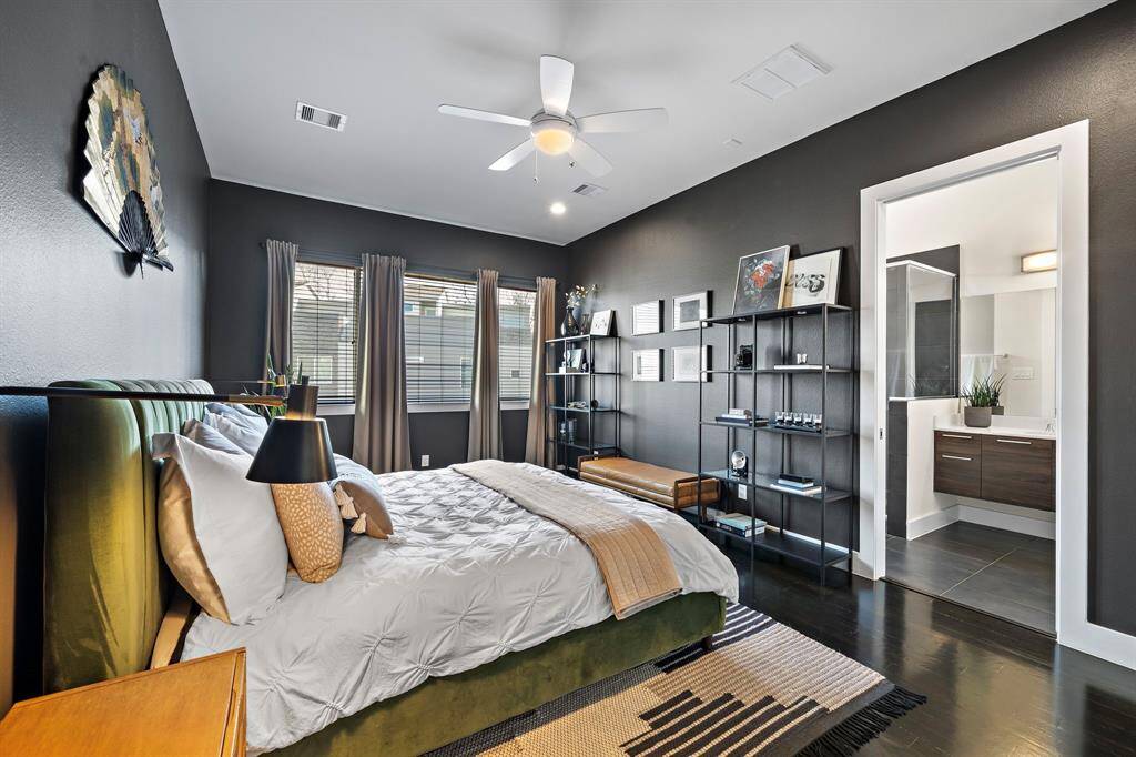 Step into a contemporary bedroom featuring sleek hardwood floors and soft, neutral tones. The space offers a direct access to an elegant ensuite bath, making it a serene retreat for relaxation.