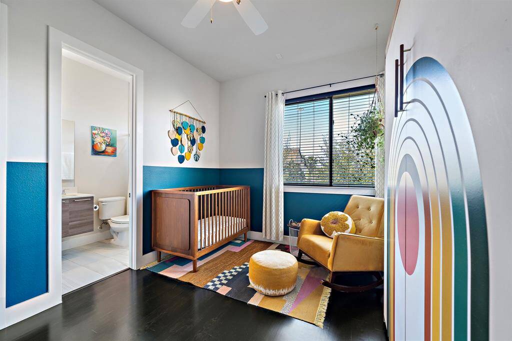 The secondary bedroom offers a cozy retreat with stylish decor and abundant natural light. Featuring a large window, sleek flooring, and a roomy closet, it's an ideal space for comfort and personalization.
