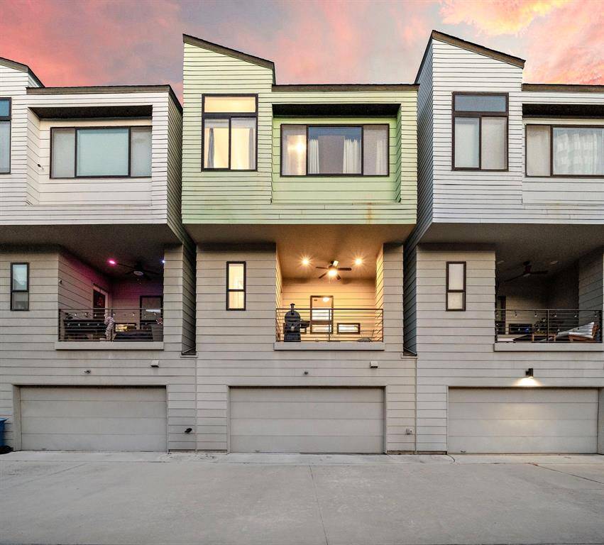 The contemporary three-story facade showcases an architectural design with sleek lines and expansive windows. The oversized 2-car garage provides ample space, complemented by a gated entry for added security. This low-maintenance lock-and-leave home offers a seamless urban lifestyle with quick access to downtown amenities.