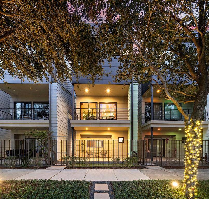 Discover urban elegance in this contemporary gem with a façade framed by lush greenery and a tree-lined sidewalk. The gated entry courtyard enhances privacy, while the large windows invite natural light into every level. Perfectly positioned in La Ville Saint Emanuel, this home offers seamless access to Houston's vibrant lifestyle and top amenities.