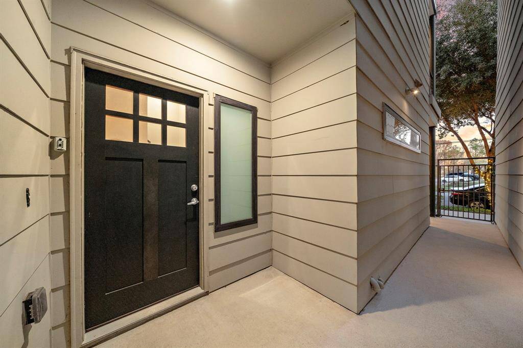 Welcome to your new home through this modern, gated entry corridor, offering both privacy and security. The contemporary design enhances the overall appeal, setting a welcoming tone as you step inside.