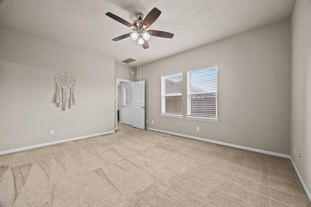 Spacious primary bedroom with ample natural light and room for all of your furniture needs.