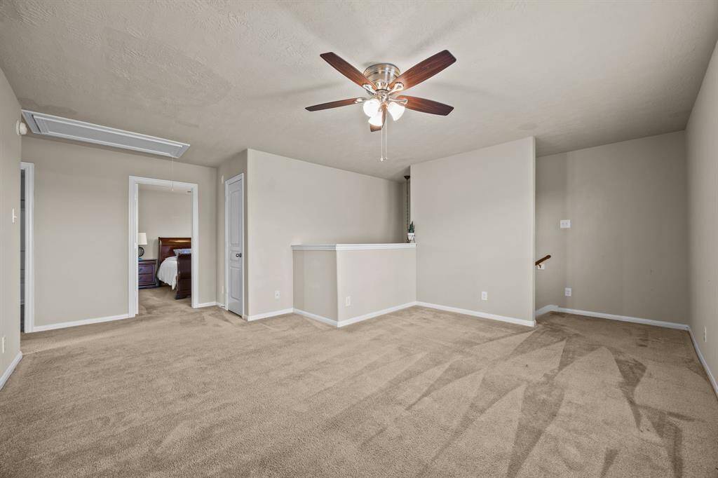 Perfect for entertaining, this spacious second-floor game room is a family favorite.