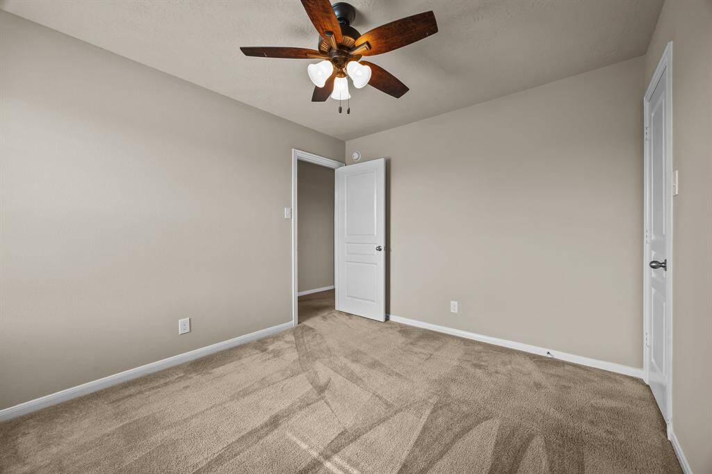 Cozy second bedroom with neutral tones, perfect for guests or a home office.