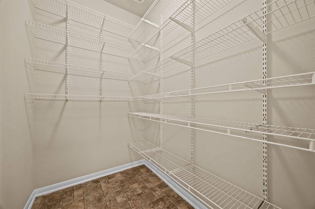 Convenient storage closet adjacent to the kitchen, perfect for large appliances or additional pantry space.