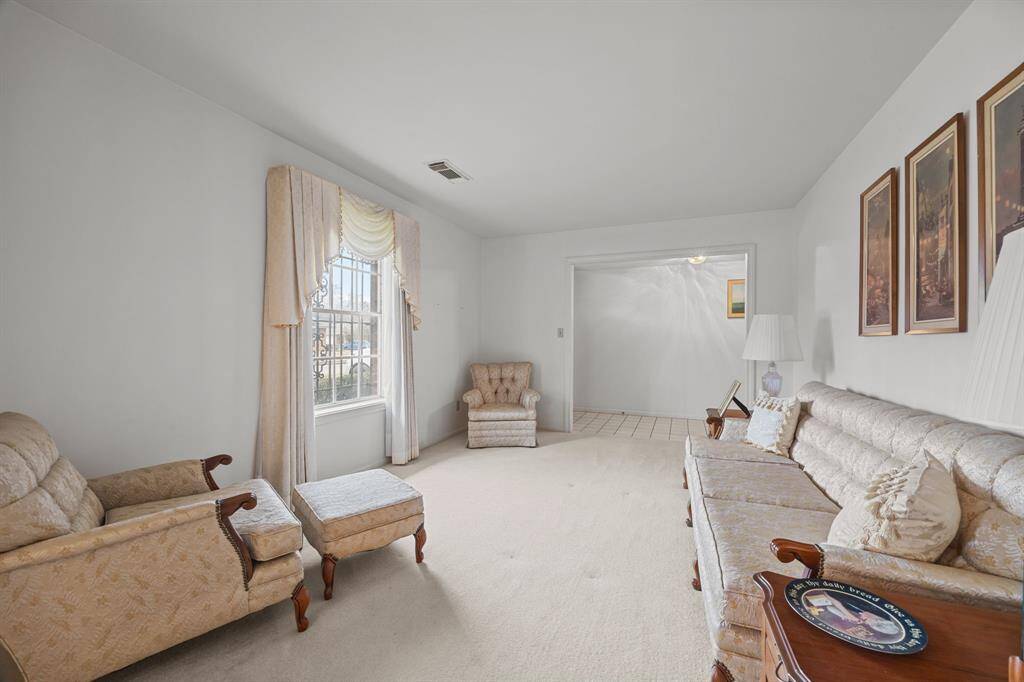 Formal Living Room at the front of the house connects to the Formal Dining Room. Large Front Windows for plenty of natural light in this space.