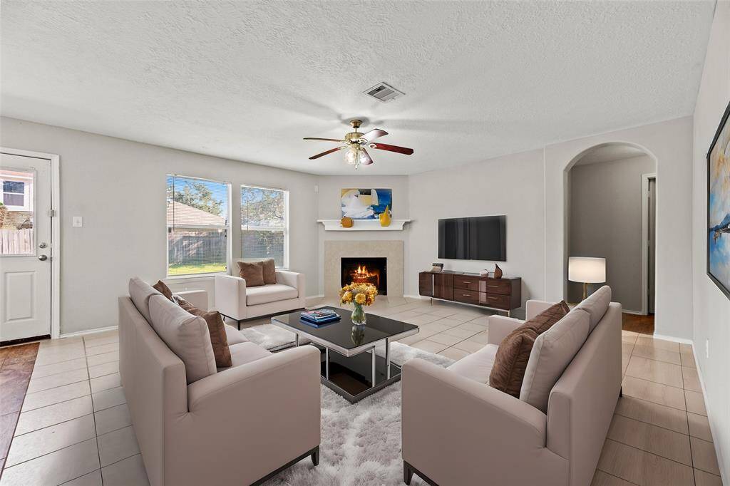No matter the style or design, the inviting center fireplace becomes a focal point that anchors the room and invites people to gather and linger, making it a cherished feature of the living area.