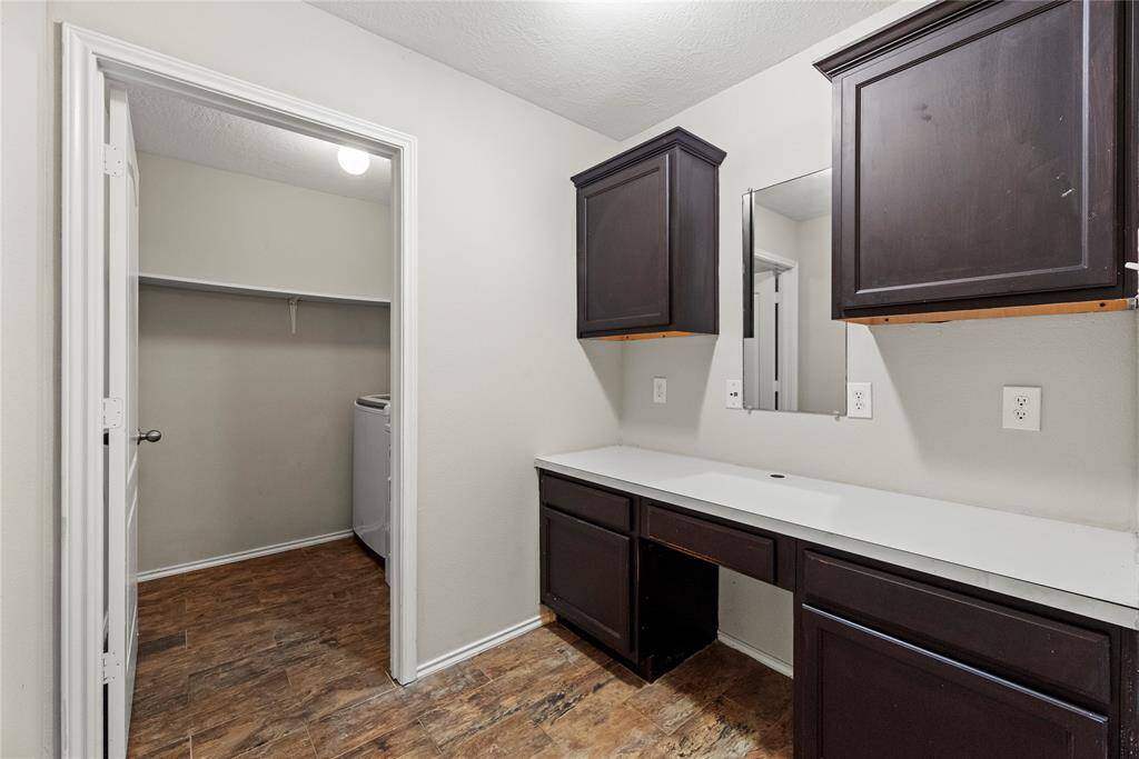 An additional desk or work area with coordinating counter and cabinet space is perfect for homework or crafting.