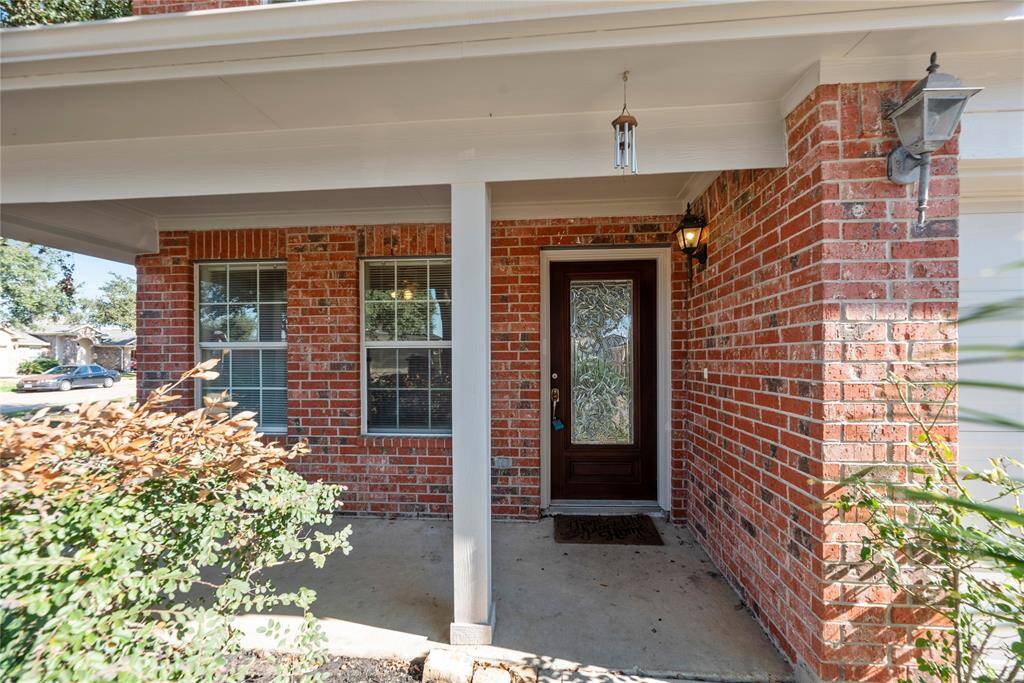 The charming brick-front porch provides the perfect spot to relax and unwind, offering a peaceful place to sit and take in the sights and sounds of the neighborhood.