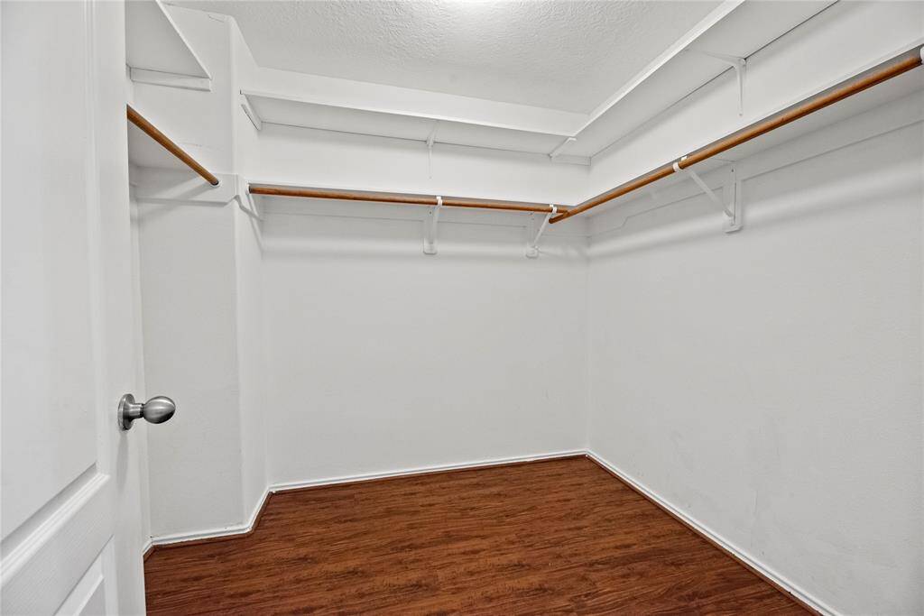 The primary closet offers ample space to store all your clothes and keep everything organized.
