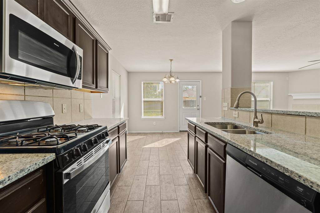 Granite countertops paired with a coordinating backsplash not only provide a durable and elegant surface for food preparation but also add a touch of luxury and sophistication to the kitchen.