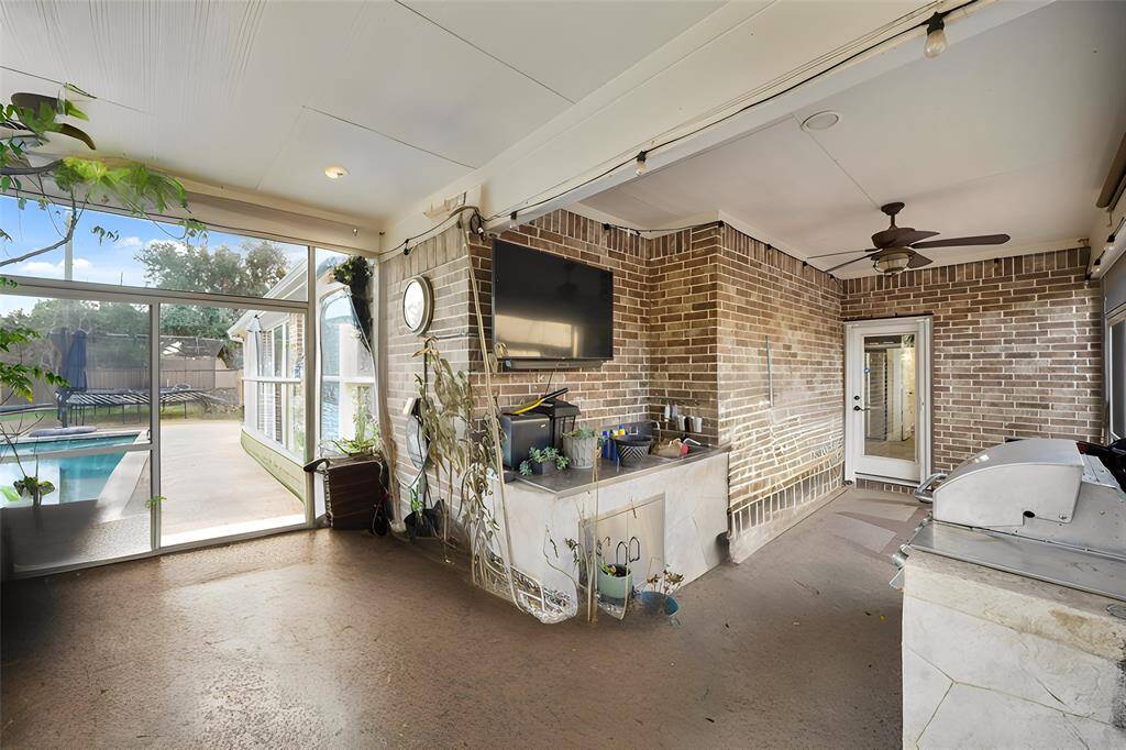 The generously sized backyard is an outdoor oasis, featuring a screened-in covered patio perfect for relaxation and dining.