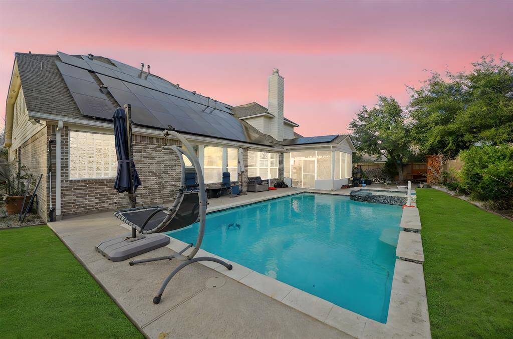 The family room features custom built-ins and elegant crown molding. Floor-to-ceiling windows offer breathtaking views of the sparkling pool, filling the room with natural light and a serene ambiance.