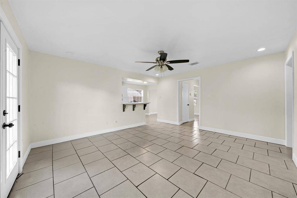 Another view of your living room with views into your kitchen.