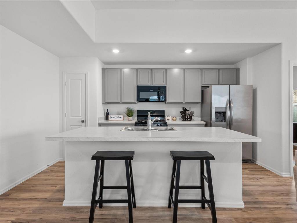A modern kitchen with a large island, ample counter space, and seating—ideal for casual meals or socializing.