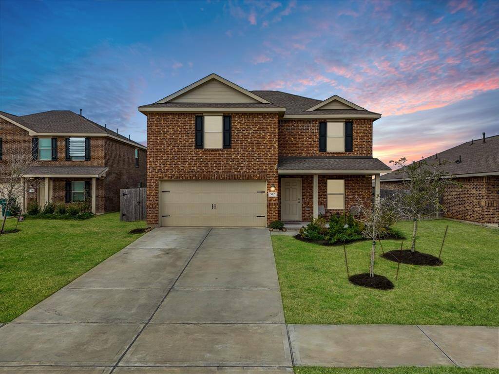 This 2022-built brick home exudes curb appeal with fresh landscaping, a welcoming front porch, and a two-car garage.