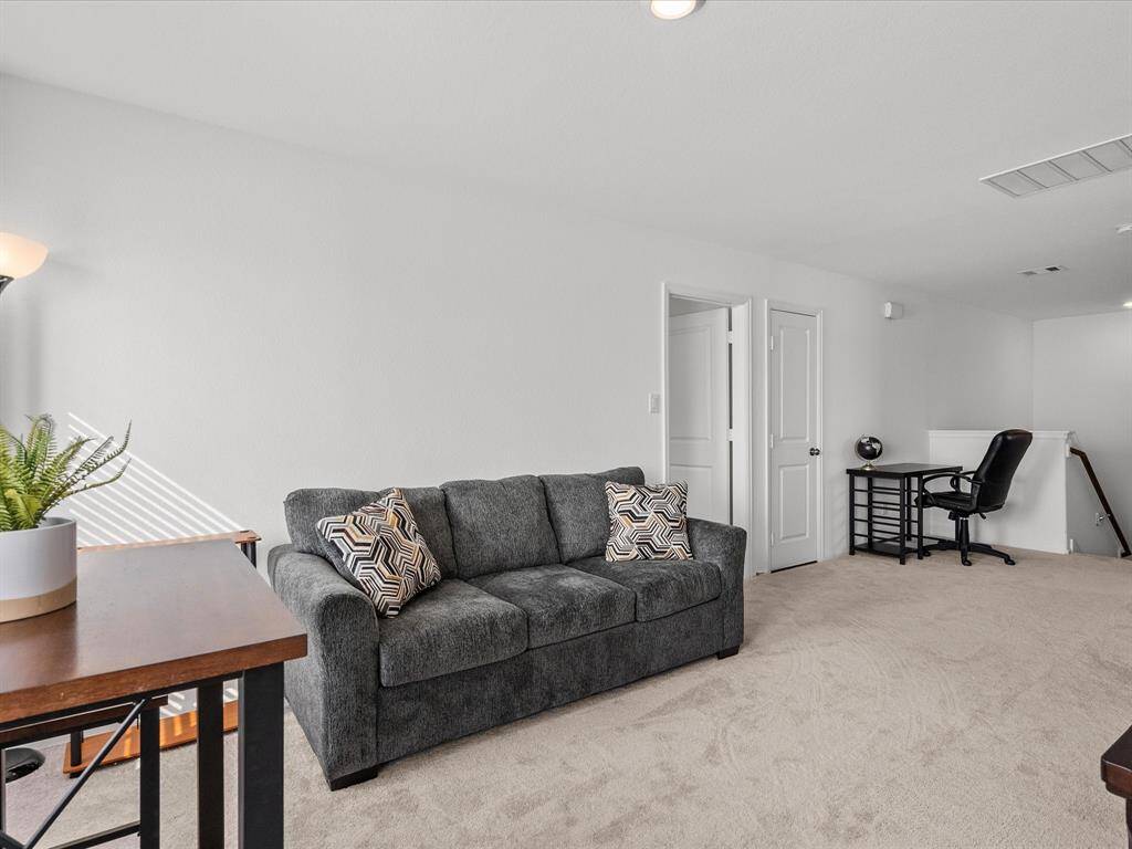 A light-filled upstairs game room with flexible space for relaxing, entertaining, or hobbies.