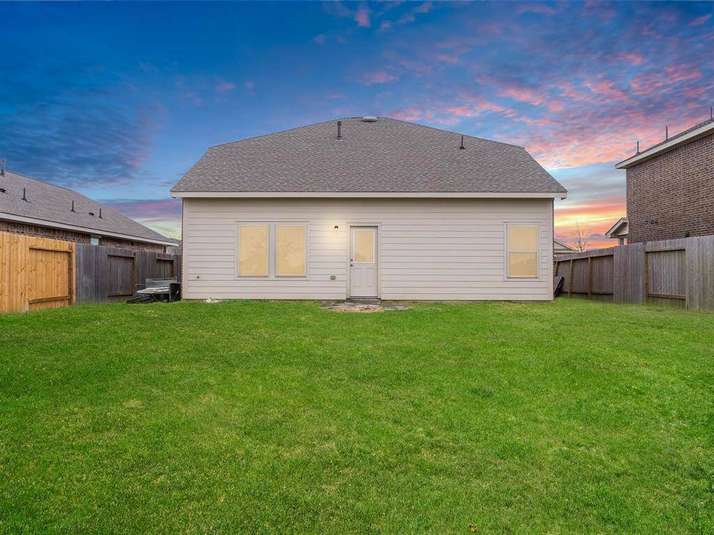 The home's exterior features a spacious backyard, a patio for outdoor relaxation, and ample room for entertaining or play.