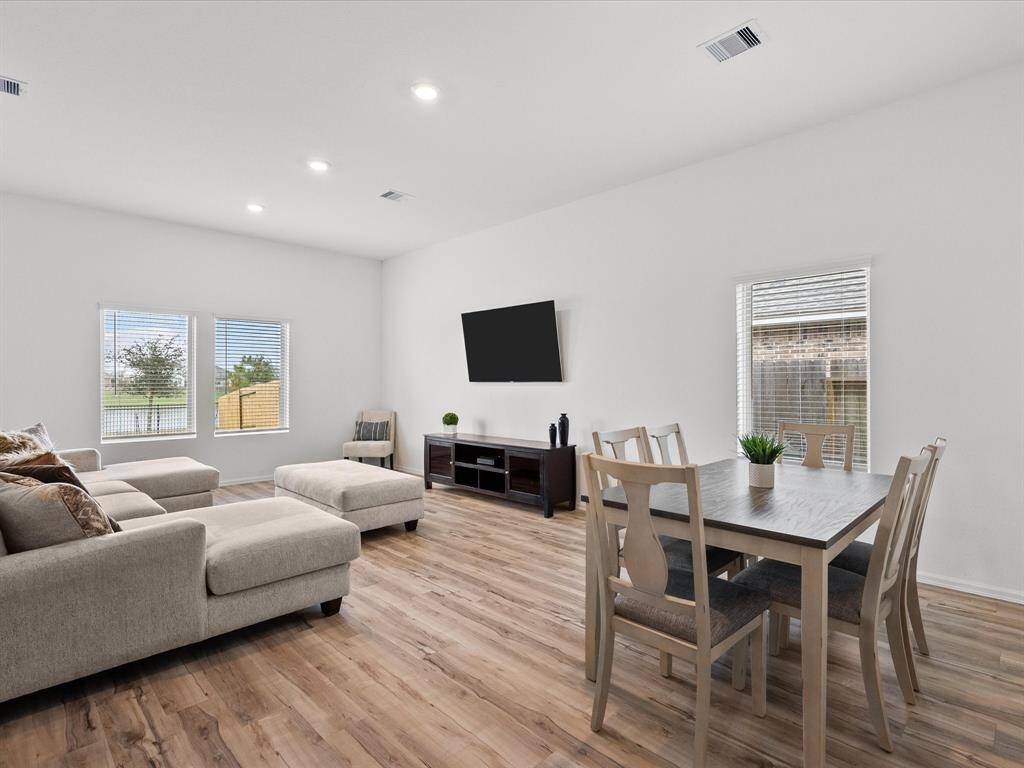 Step inside to a light and airy interior with luxury vinyl plank flooring and a clear view to the spacious living area.