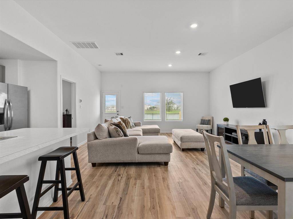 The open-concept living space is perfect for hosting, with large windows letting in natural light and stunning water views.