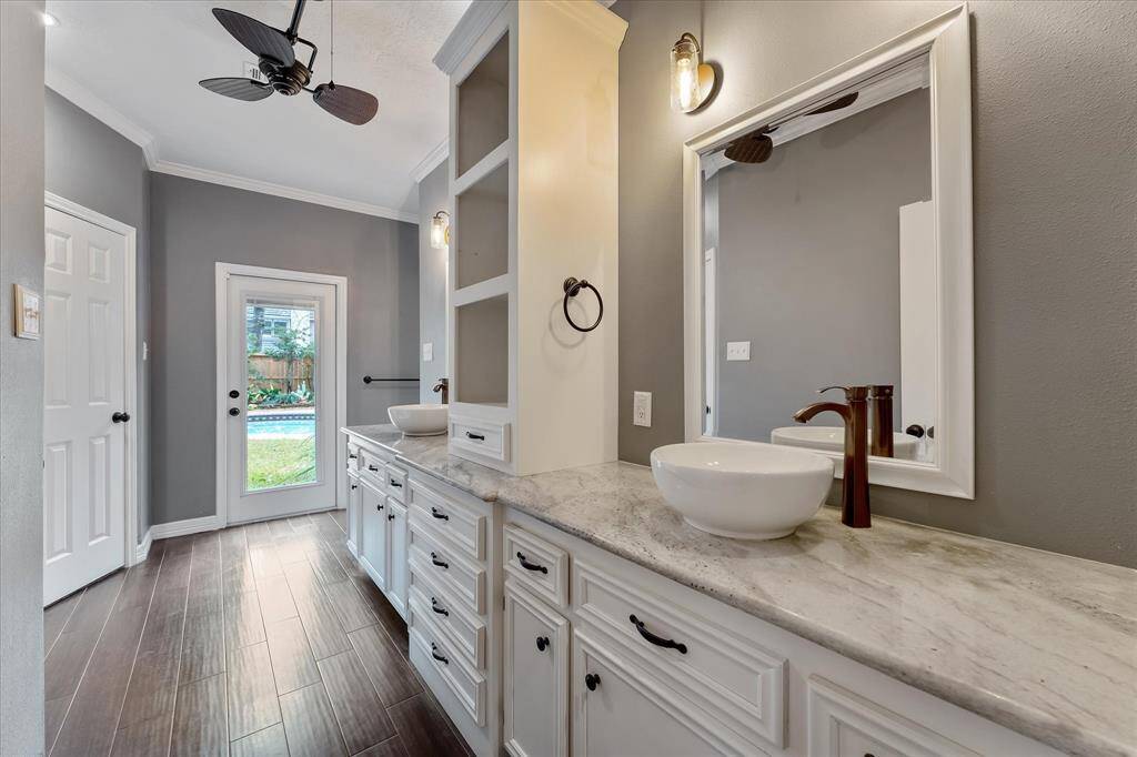 Updated primary bath with double vessel sinks and extra storage.