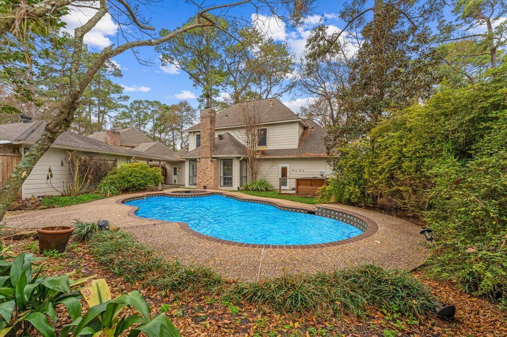 View of the landscaped backyard and pool.