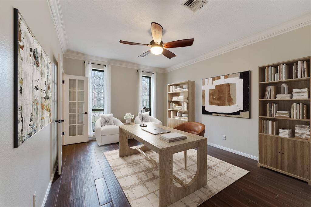 Home office with double French doors, rich flooring and crown molding. Virtually Staged.