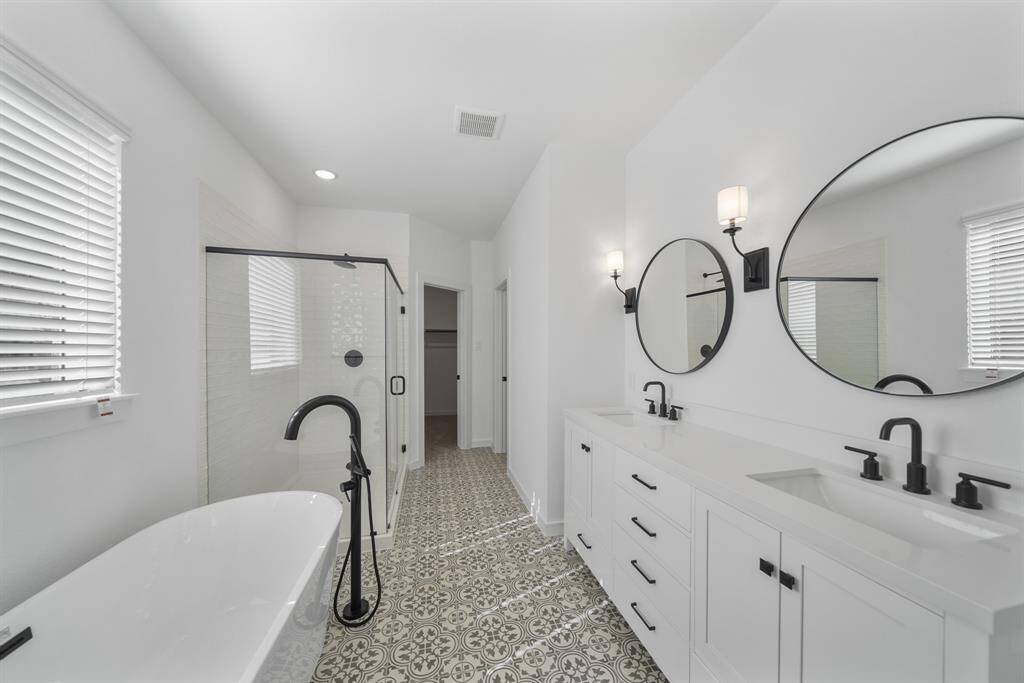 Relaxing primary bath with dual sinks, freestanding tub and shower (*Photo not of actual home and used for illustration purposes only.)