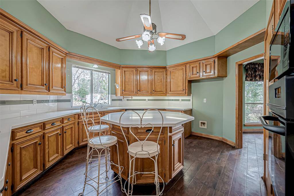 The center island adds both functionality and style, providing extra counter space for food prep, casual dining, or entertaining.