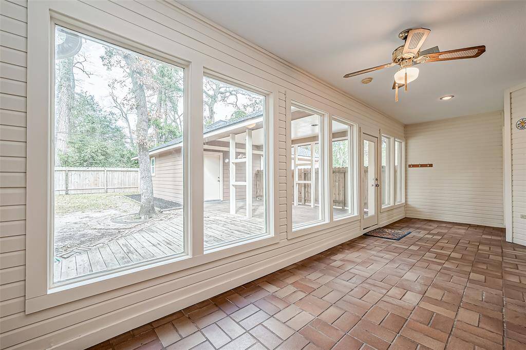 Just off the family room, relax in the inviting sunroom, a perfect spot to unwind and enjoy the natural light.