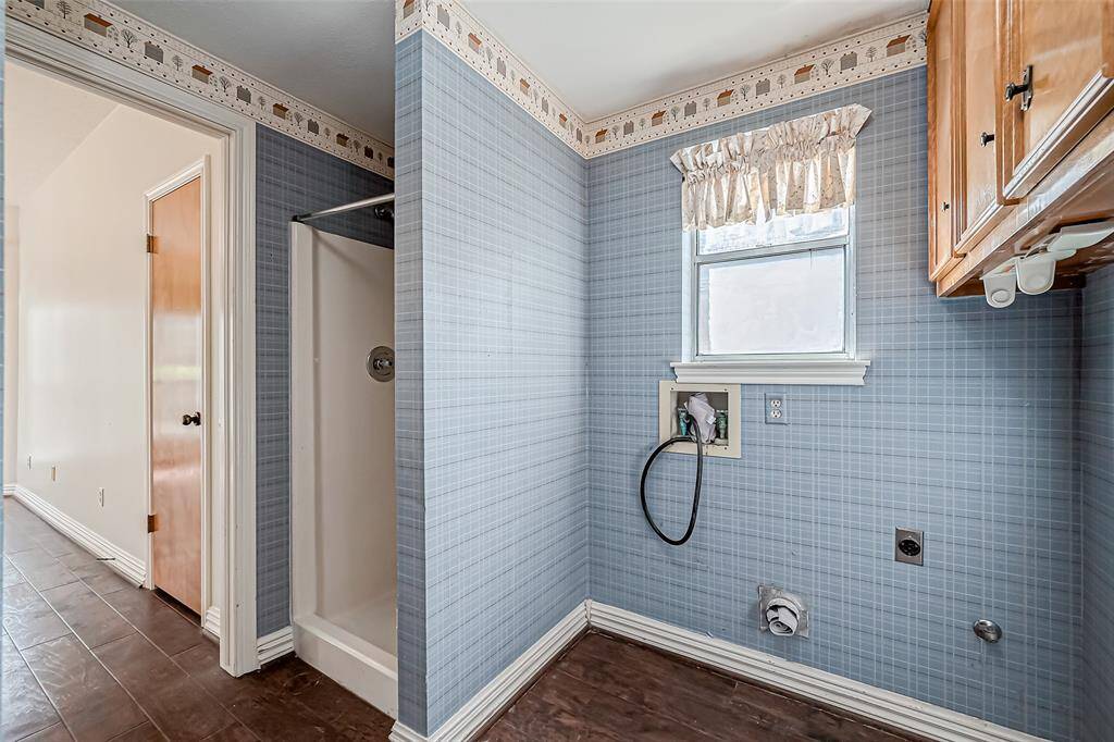 Laundry area with shower.