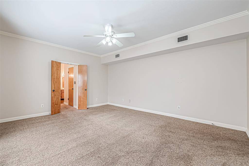 This generously sized primary bedroom offers a peaceful retreat with plenty of room for a king-sized bed and additional seating.
