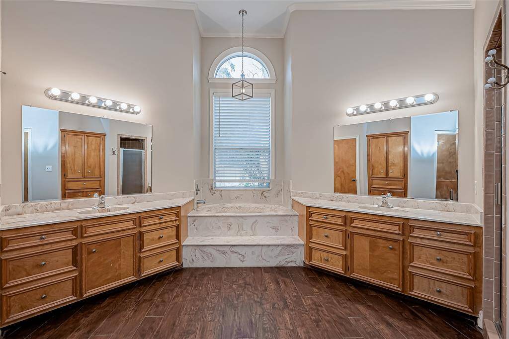 Primary ensuite with garden tub and separate vanities.